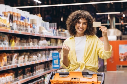 woman saving money at the grocery store