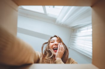 surprised woman opening a box