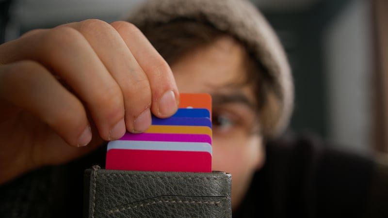 man looking at wallet with forgotten loyalty cards