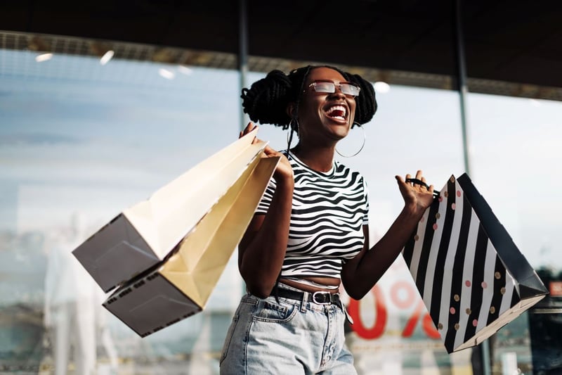 A shopper happily holds her bags customer retention