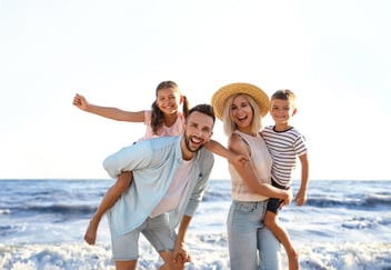 family vacationing on the beach
