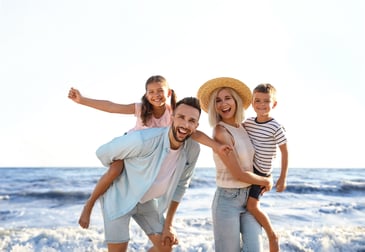 family vacationing on the beach