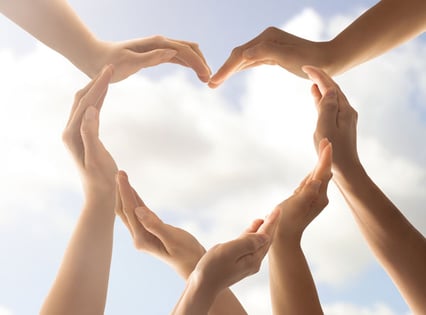 hands form the shape of a heart engaging members with post-purchase funnel