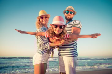 travel family on the beach saving with travel discounts