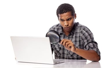 man-at-computer-with-magnifying-glass-shutterstock