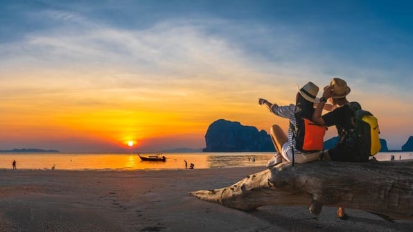 travelers enjoy a beautiful beach sunset