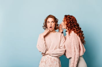 Two girls gossiping Mouth to mouth marketing