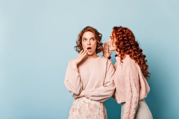 Two girls gossiping Mouth to mouth marketing